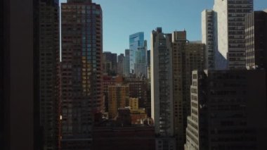 Yüksek katlı apartmanlar arasında ileriye doğru uçar. Şehirdeki çeşitli cephelerde. Manhattan, New York City, ABD.