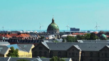 Frederiks Kirke 'ün şehir merkezindeki çatıların üstündeki görüntüsü çok güzel. Arka planda deniz kıyısının rüzgâr tarlası. Kopenhag, Danimarka.
