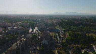 Tiber Nehri 'nin yüksek açılı manzarası, yol köprüsü ve set. Alacakaranlıkta şehir manzarasını göstererek yukarı kaldır. Roma, İtalya.