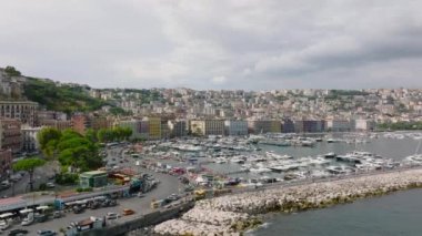 Lüks yatları ve popüler seyahat noktalarında yelkenli tekneleri olan bir marina görüntüsü. Napoli, İtalya.