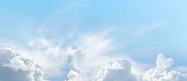 Beautiful summer sky wispy romantic cloudscape - wide pale blue with various cloud formations ideal for vacation holiday getaway travel theme or environment consciousness theme