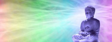 Contemplating Buddha Rainbow background template - wispy flowing multicoloured red orange yellow green blue purple pink wide background and a buddha in lotus position on right side with copy space                               