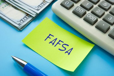 Business concept about FAFSA Free Application for Federal Student Aid with phrase on the piece of paper. clipart