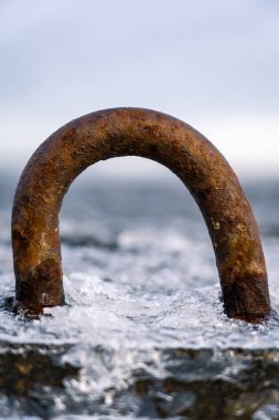 İskelede buzla kaplı paslı çelik kancalar..