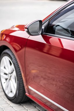 Close up detail on the red car taillight modern red crossover car. Exterior detail business automobile.