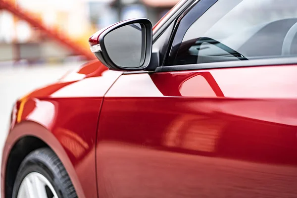 Close up detail on the red car taillight modern red crossover car. Exterior detail business automobile.