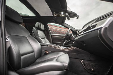 Car inside. Interior prestige modern car. Comfortable leather seats. Black cockpit with on isolated white background.