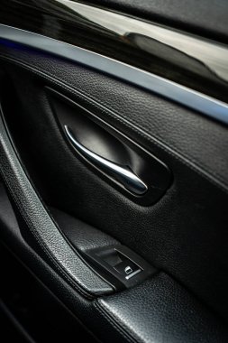 Car interior. Front handle door panel. Car open door window buttons