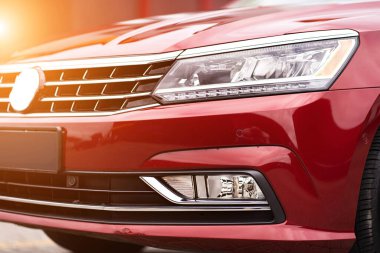 Close up detail on the red car taillight modern red crossover car. Exterior detail business automobile.