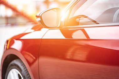 Close up detail on the red car taillight modern red crossover car. Exterior detail business automobile.