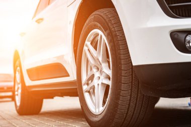 Compact white executive car, with business car, large chrome grille.