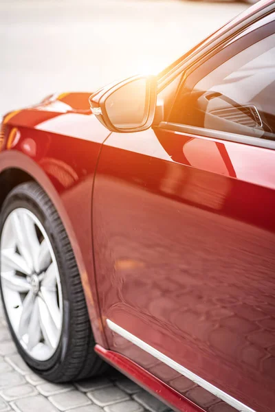 Close up detail on the red car taillight modern red crossover car. Exterior detail business automobile.