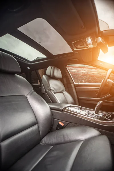 Car inside. Interior prestige modern car. Comfortable leather seats. Black cockpit with on isolated white background.
