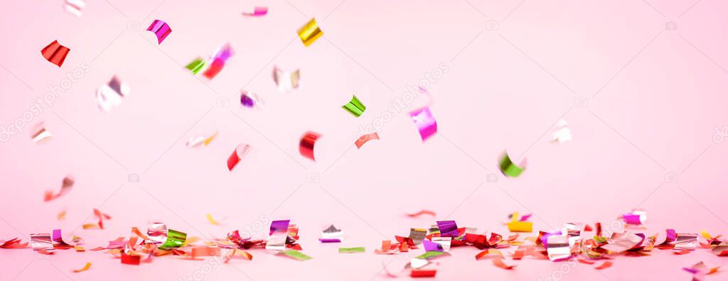 colorful confetti on a pink background. festive background