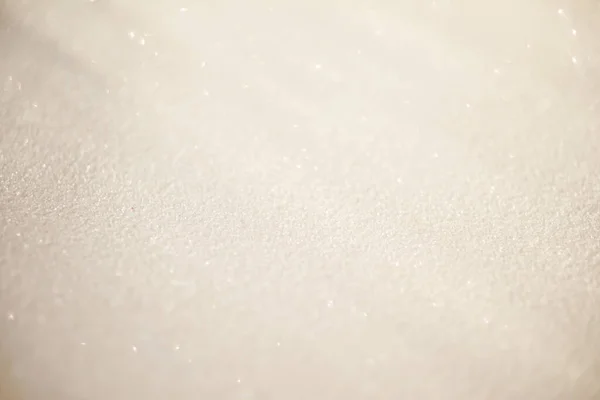 White blurred glitter background with rays of light on it, looks like snow. — Stock Photo, Image