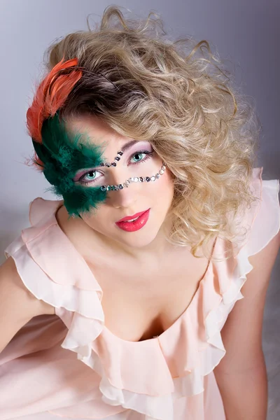 Die schöne junge Frau in einer grünen geheimnisvollen venezianischen Maske ein Neujahrskarneval, Weihnachtsmaskerade, ein Tanzclub, heimliche Nachtparty, mit wunderschönem Make-up — Stockfoto