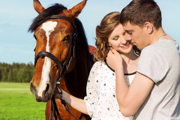 Amar hermosa pareja de chicos y chicas en el campo de caminar en caballos — Foto de Stock