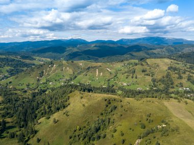 Yazın Ukrayna Karpatları 'nın yeşil dağları. Yamaçlarda kozalaklı ağaçlar. Hava aracı görünümü.