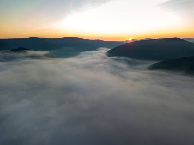 Ukrayna Karpatları 'nda sisin üstünde gün doğumu. Hava aracı görünümü.