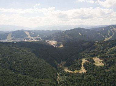 Yazın Ukrayna Karpatları 'nın yeşil dağları. Güneşli bir gün, nadir bulutlar. Hava aracı görünümü.