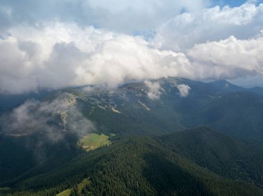 Yazın Ukrayna Karpatları 'nın yeşil dağları. Güneşli bir gün, nadir bulutlar. Hava aracı görünümü.