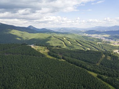 Yazın Ukrayna Karpat Dağları 'nın yeşil yamaçlarında. Bulutlu bir sabah, alçak bulutlar. Hava aracı görünümü.