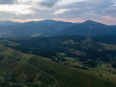 Ukrayna Karpatları 'ndaki dağların üzerinden gün batımı. İyi akşamlar. Hava aracı görünümü.