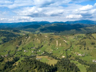 Yazın Ukrayna Karpatları 'nın yeşil dağları. Yamaçlarda kozalaklı ağaçlar. Hava aracı görünümü.