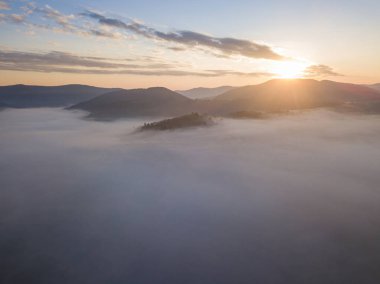 Ukrayna Karpatları 'nda sisin üstünde gün doğumu. Hava aracı görünümü.