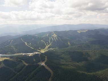Yazın Ukrayna Karpatları 'nın yeşil dağları. Güneşli bir gün, nadir bulutlar. Hava aracı görünümü.