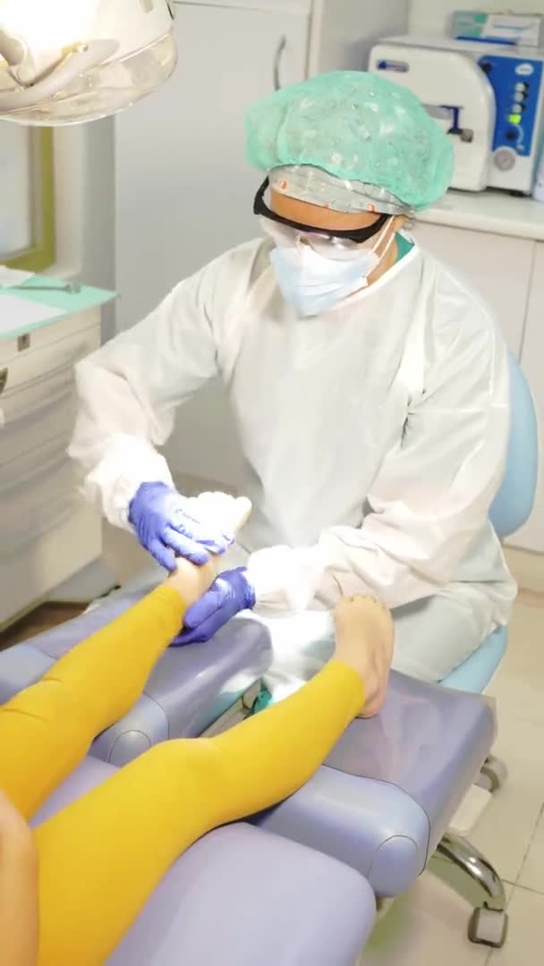 Woman Podologist Examining Patient Chiropody Treatment Vertical Video — Stock Video