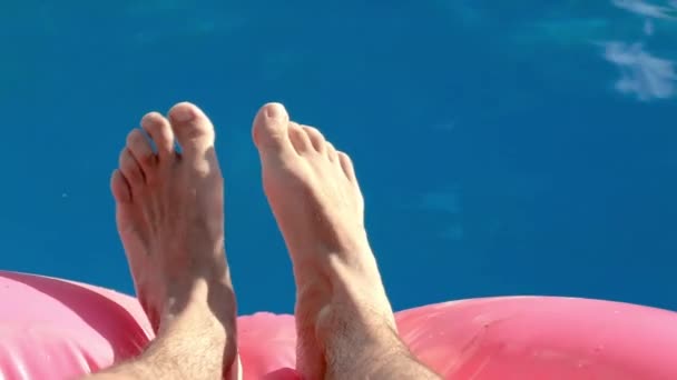 Feet relaxing point of view: in a swimming pool — ストック動画