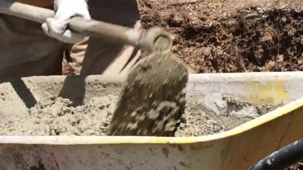 Man mixing cement in a cart — Stock Video