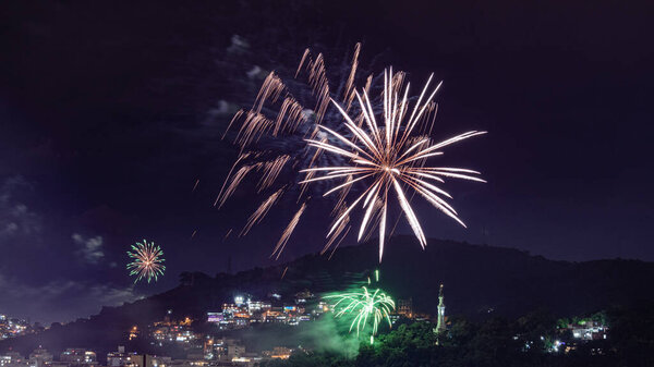 Night images with New Year's (Reveillon) fireworks exploding in the sky. Event held for the 2022 arrival in Niteroi, Rio de Janeiro, Brazil. Due to the COVID-19 pandemic, the municipal government held the traditional Reveillon party without crowding.