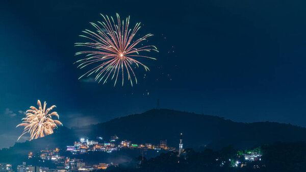Night images with New Year's (Reveillon) fireworks exploding in the sky. Event held for the 2022 arrival in Niteroi, Rio de Janeiro, Brazil. Due to the COVID-19 pandemic, the municipal government held the traditional Reveillon party without crowding.