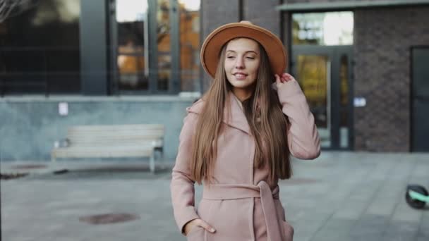 Крупним планом красива молода жінка в пальто і круглий капелюх міського фону — стокове відео