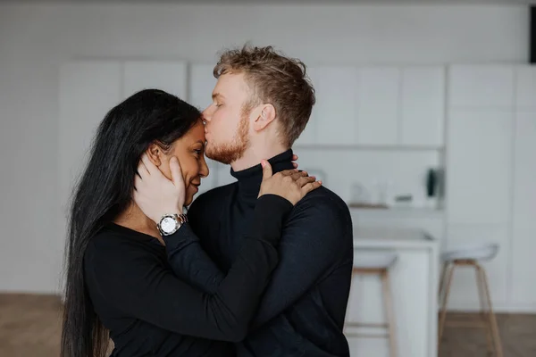 Jeune mari embrasse doucement sa femme dans le salon — Photo