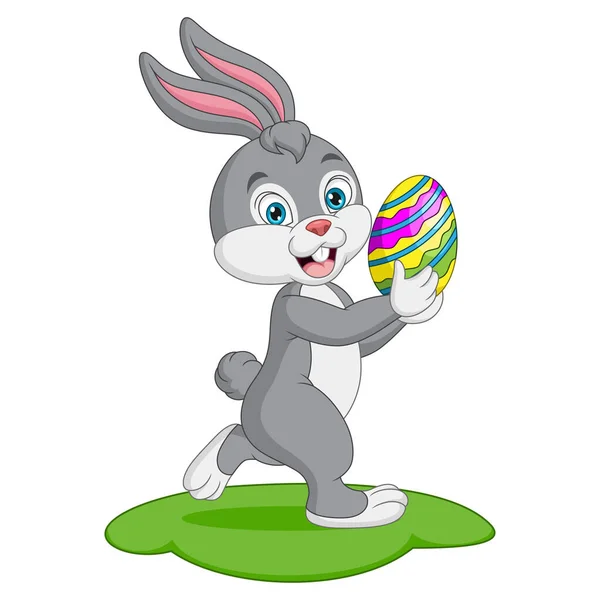 Векторная Иллюстрация Милого Кролика Несущего Пасхальное Яйцо Траве — стоковый вектор