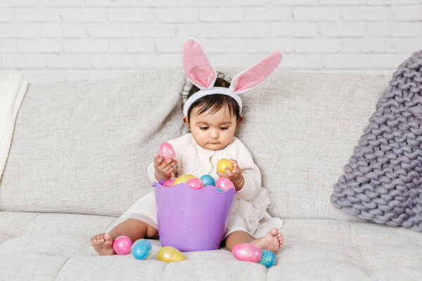 Cute Indian Baby Girl Pink Bunny Ears Basket Colorful Eggs Stock Image