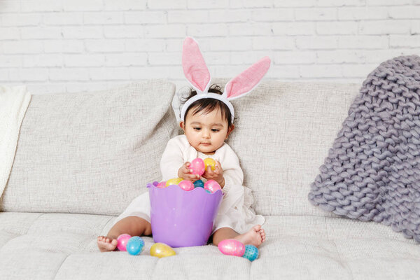 Cute Indian Baby Girl Pink Bunny Ears Basket Colorful Eggs Stock Image