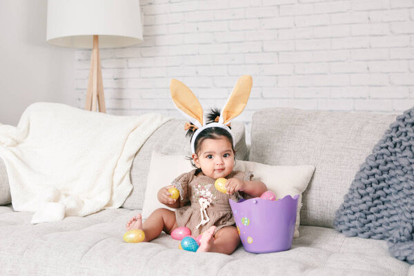 Cute Indian Baby Girl Pink Bunny Ears Basket Colorful Eggs Stock Image