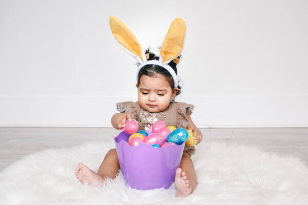 Cute Indian Baby Girl Pink Bunny Ears Basket Colorful Eggs Stock Image