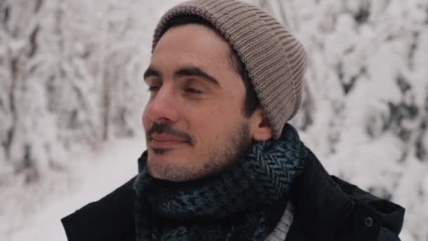 European Man Standing Smiling in WInter Forest. Snowy Winter Day. Video Portrait. Looking into Camera — Stock Video