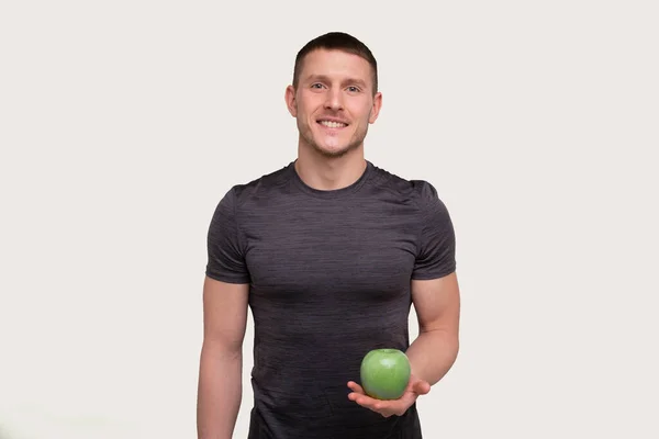 Mannen som håller Apple. Sportsman med hälsosam mat i händerna. Muskler, Abs, Biceps, Kärna. hälsosam mat, hälsosam mat, idrott, kropp, workout koncept — Stockfoto