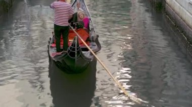 Venice, Italy - september 05, 2021:  Narrow canal with gondola in Venice, Italy. Architecture and landmark of Venice. Cozy cityscape of Venice.