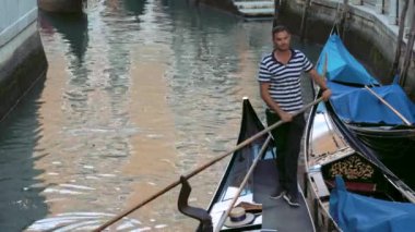 Venice, Italy - september 05, 2021:  Narrow canal with gondola in Venice, Italy. Architecture and landmark of Venice. Cozy cityscape of Venice.