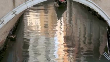 Venice, Italy - september 05, 2021:  Narrow canal with gondola in Venice, Italy. Architecture and landmark of Venice. Cozy cityscape of Venice.