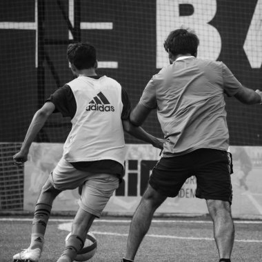 New Delhi, India - July 01 2018: Footballers of local football team during game in regional Derby championship on football pitch. Hot moment of football match on grass field stadium - Black and White