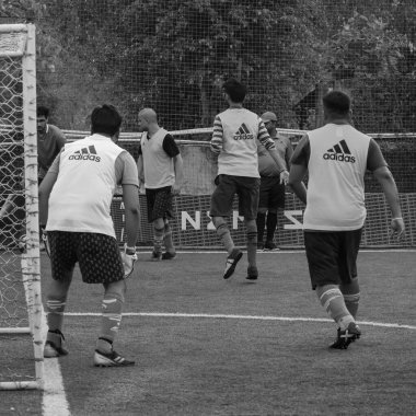New Delhi, India - July 01 2018: Footballers of local football team during game in regional Derby championship on football pitch. Hot moment of football match on grass field stadium - Black and White