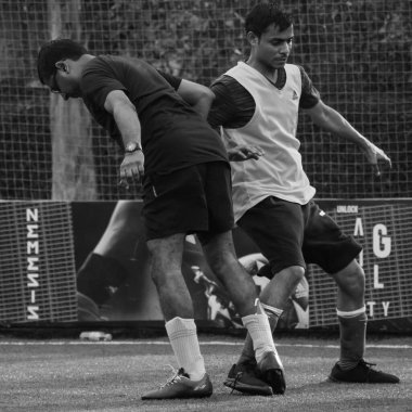 New Delhi, India - July 01 2018- Footballers of local football team during game in regional Derby championship on football pitch. Hot moment of football match on grass field stadium - Black and White